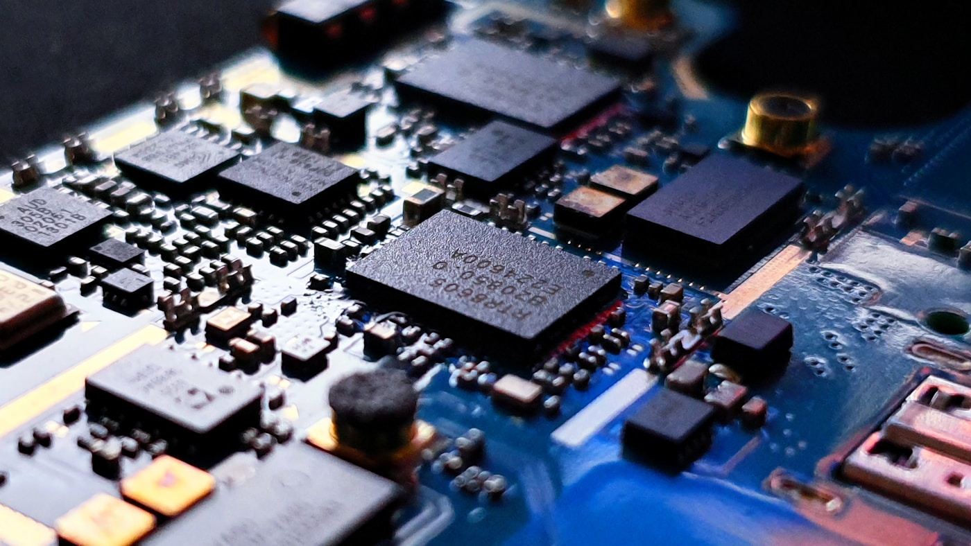Close-up of a blue printed circuit board, representing semiconductor industry customers